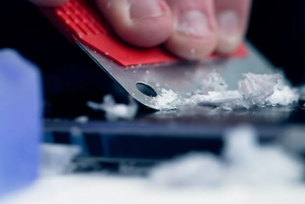 a person waxing a snowboard