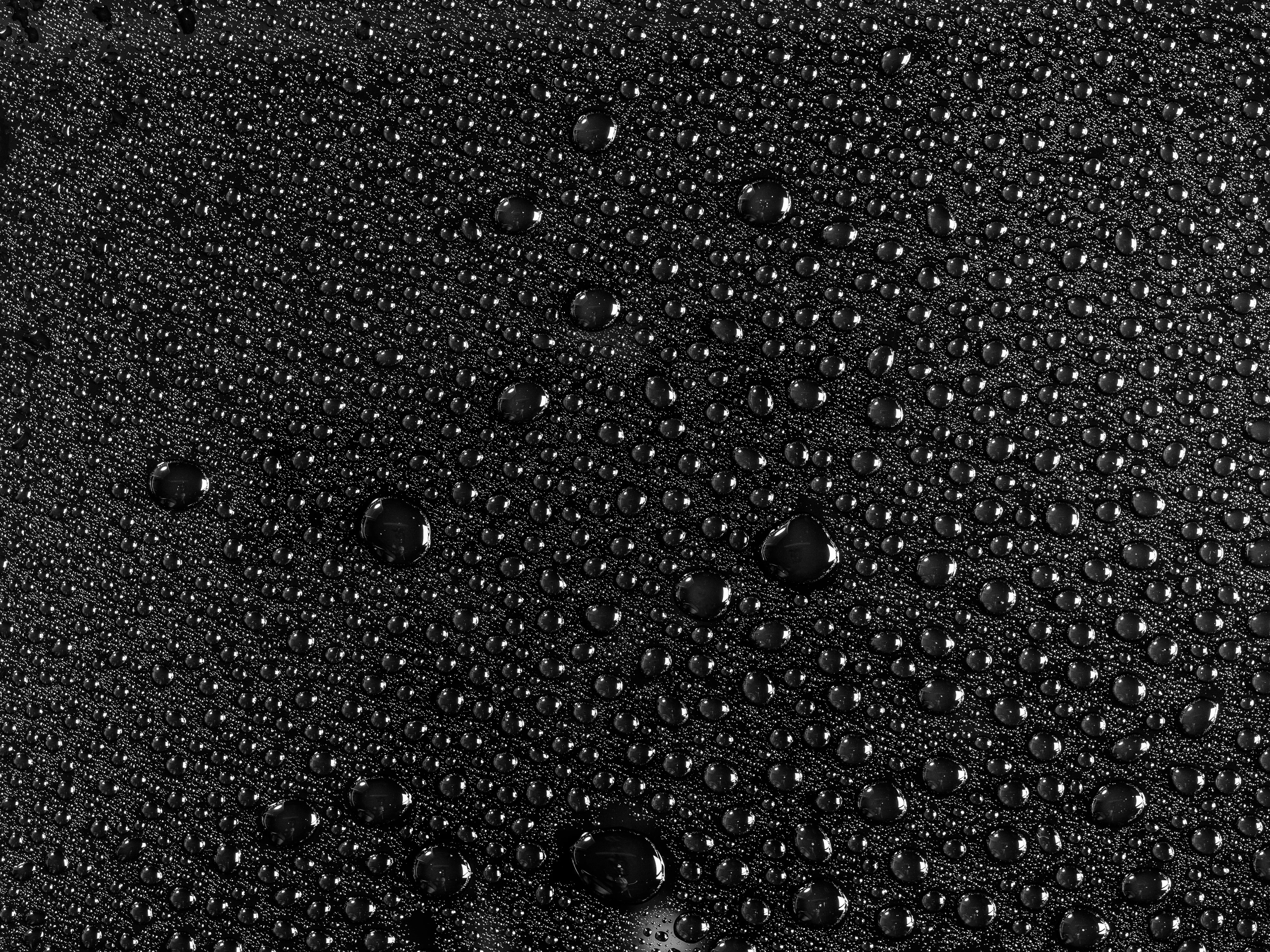 rain droplets on a black fabric surface
