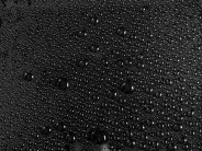 rain droplets on a black fabric surface