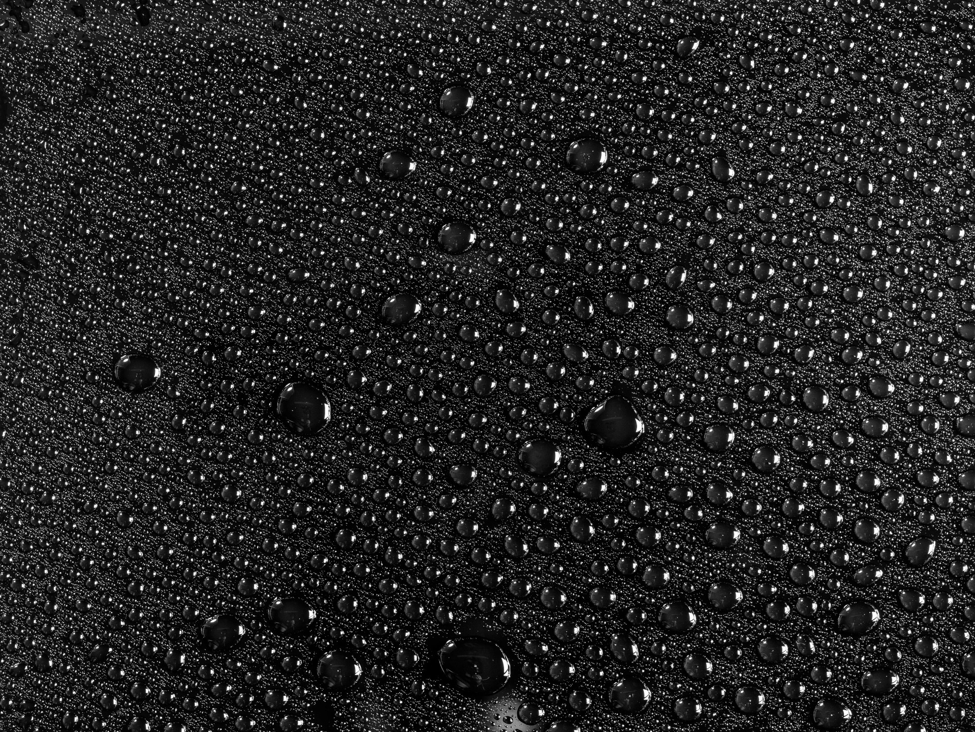 rain droplets on a black fabric surface