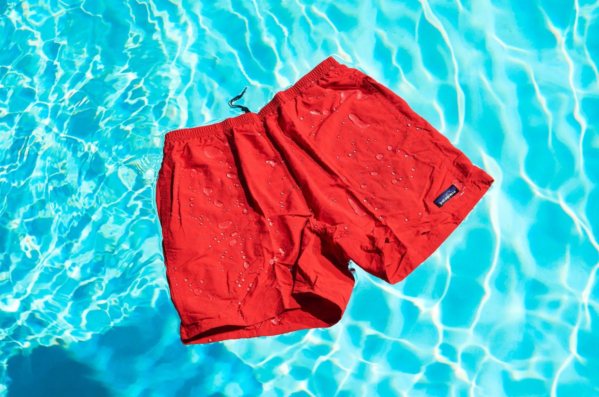 a pair of red shorts floating in a swimming pool