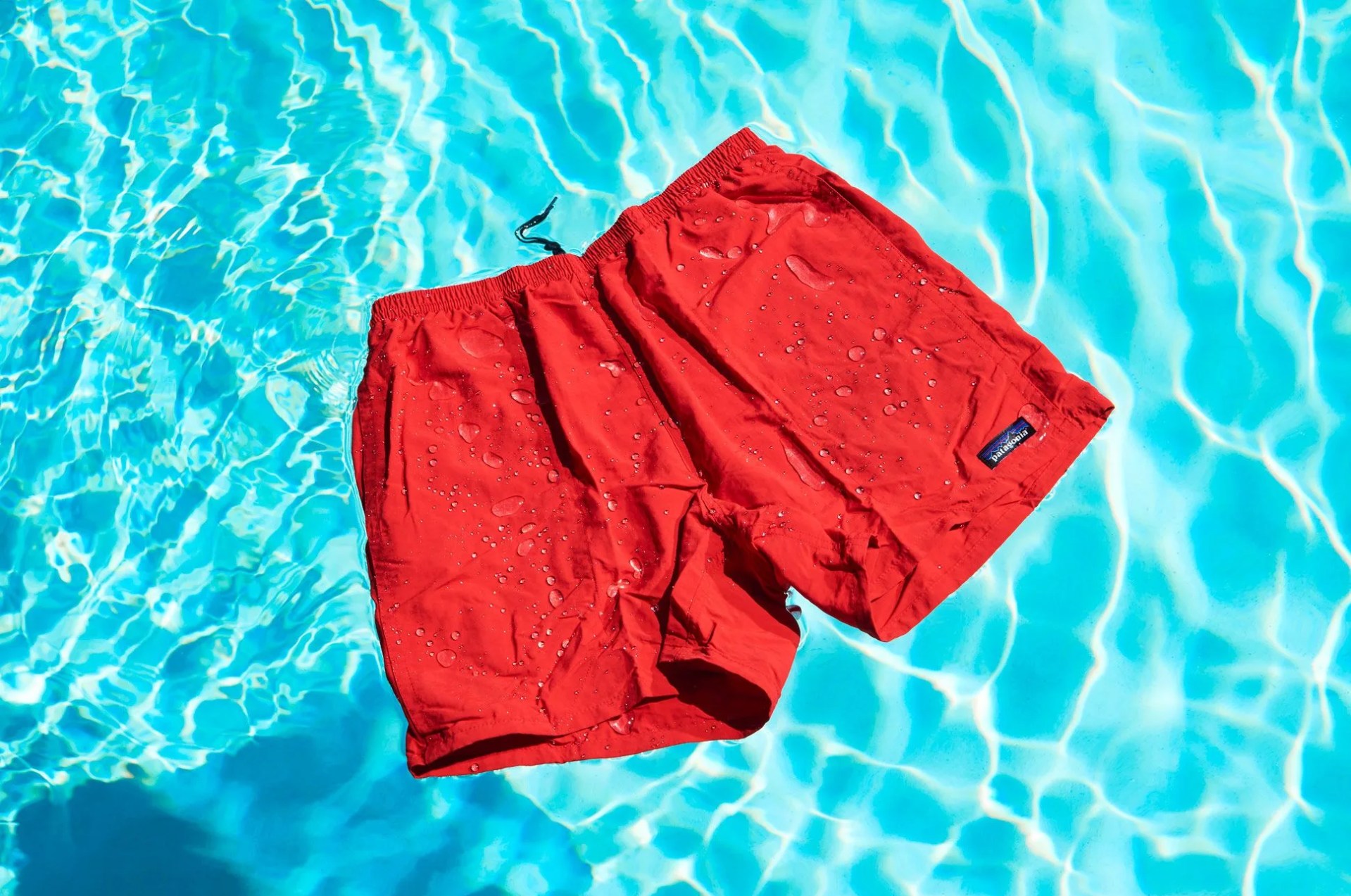 a pair of red shorts floating in a swimming pool