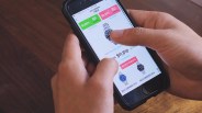 hands holding a phone and tapping on a picture of a watch within the stockx app