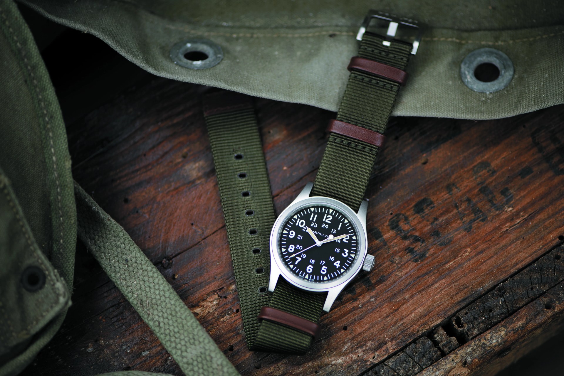 a hamilton watch laying flat on a wooden surface