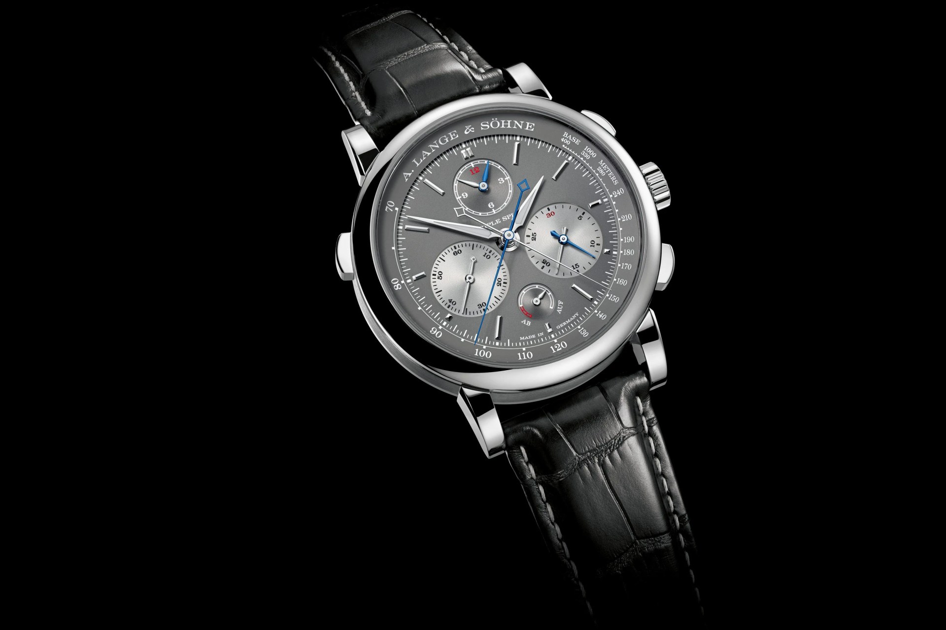 a lange sohne watch with a gray face and black crocodile strap