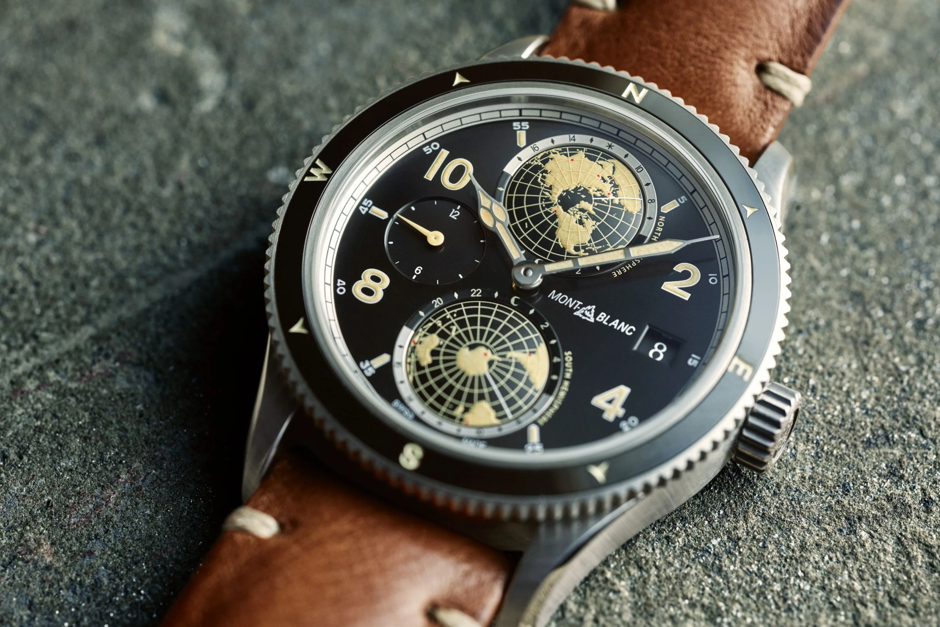 a montblanc watch with a blue face and brown leather strap
