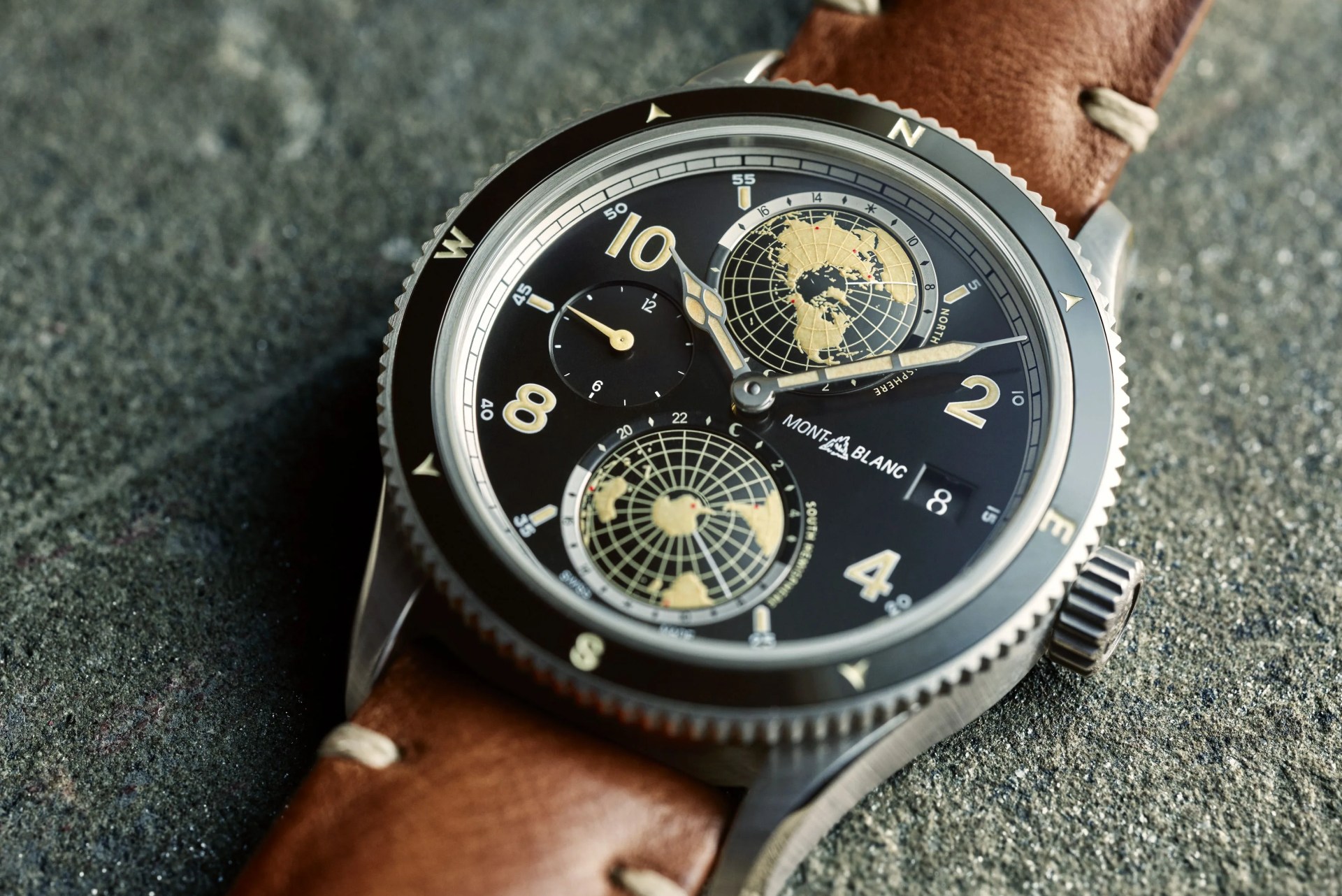 a montblanc watch with a blue face and brown leather strap