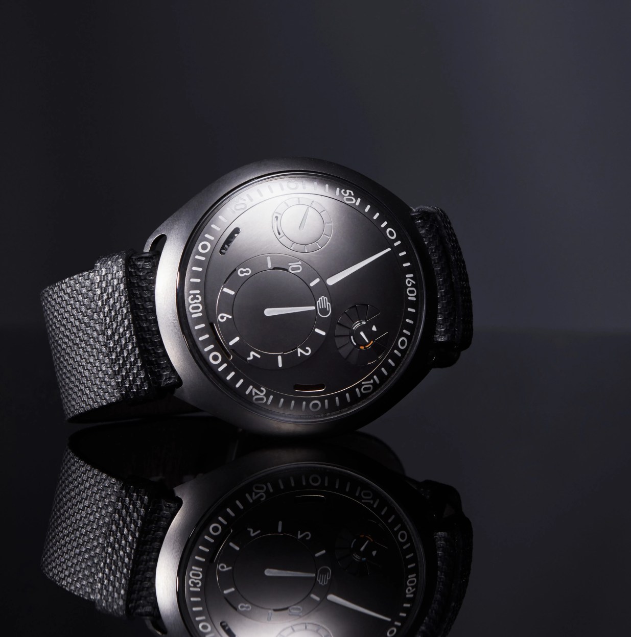 black ressence watch laying on its side