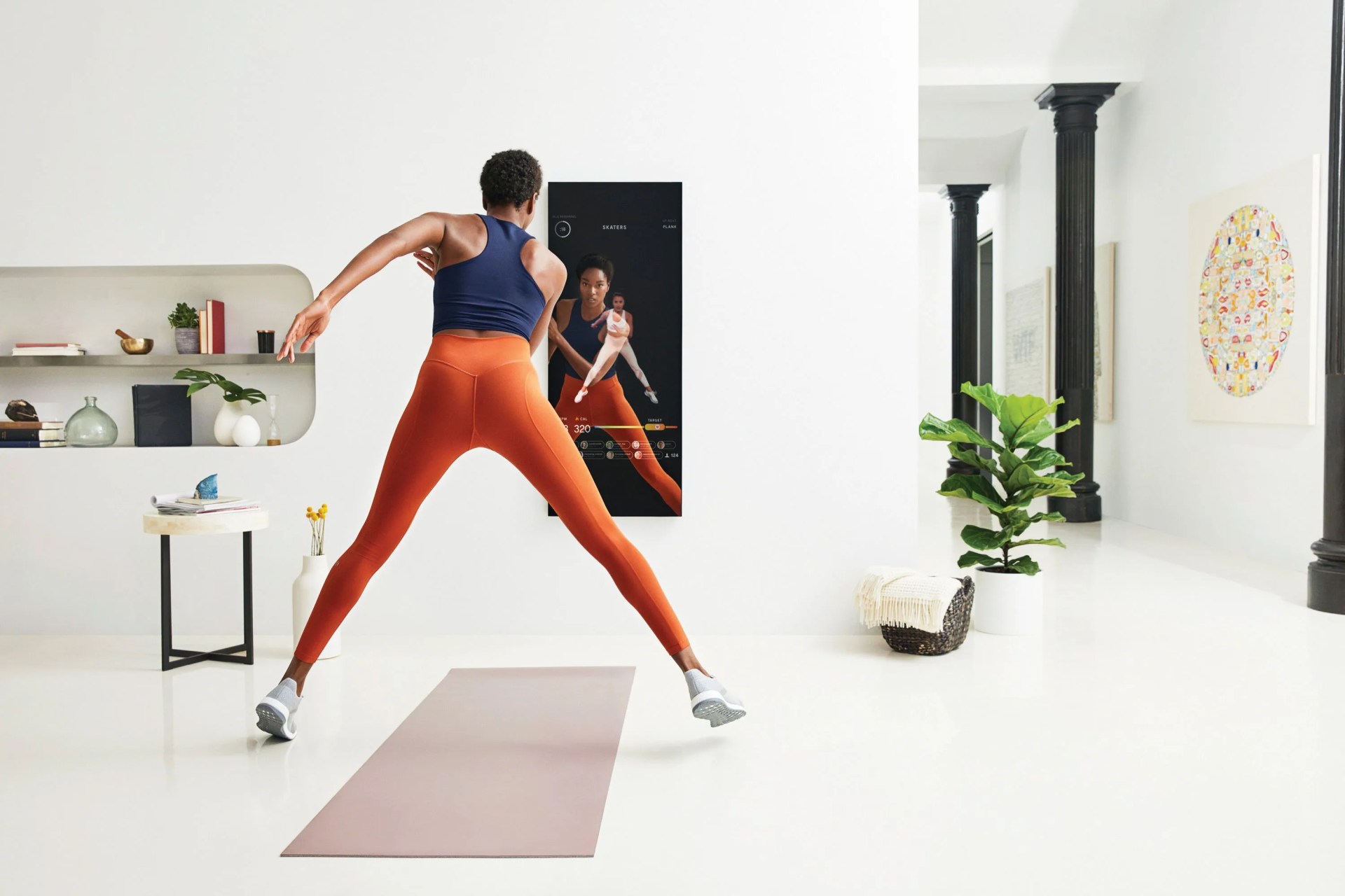 woman running in front of a fitness mirror