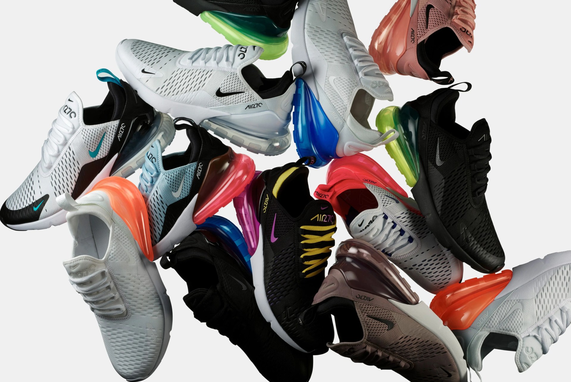 a cluster of different pairs of nike sneakers in a pile