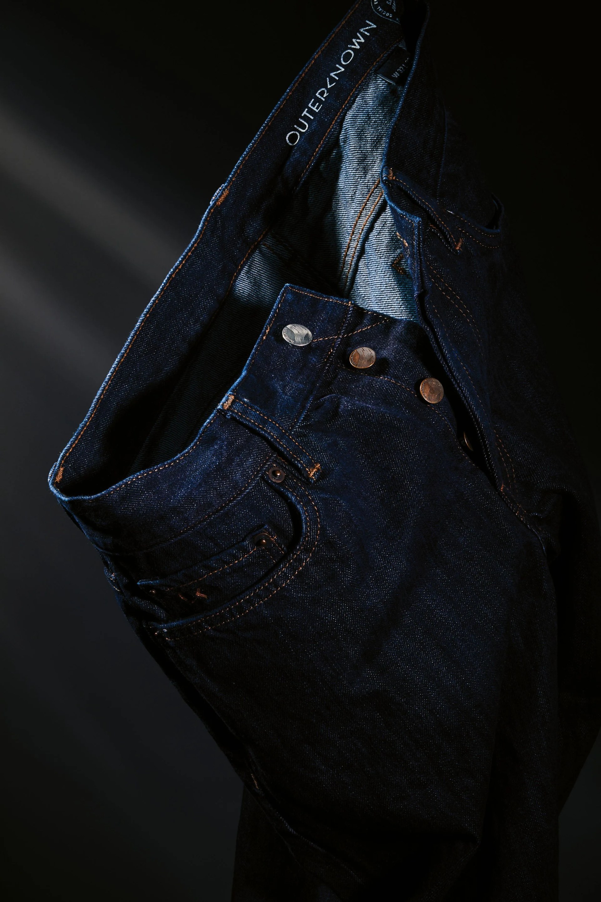 close up of unbuttoned outerknown sea jeans