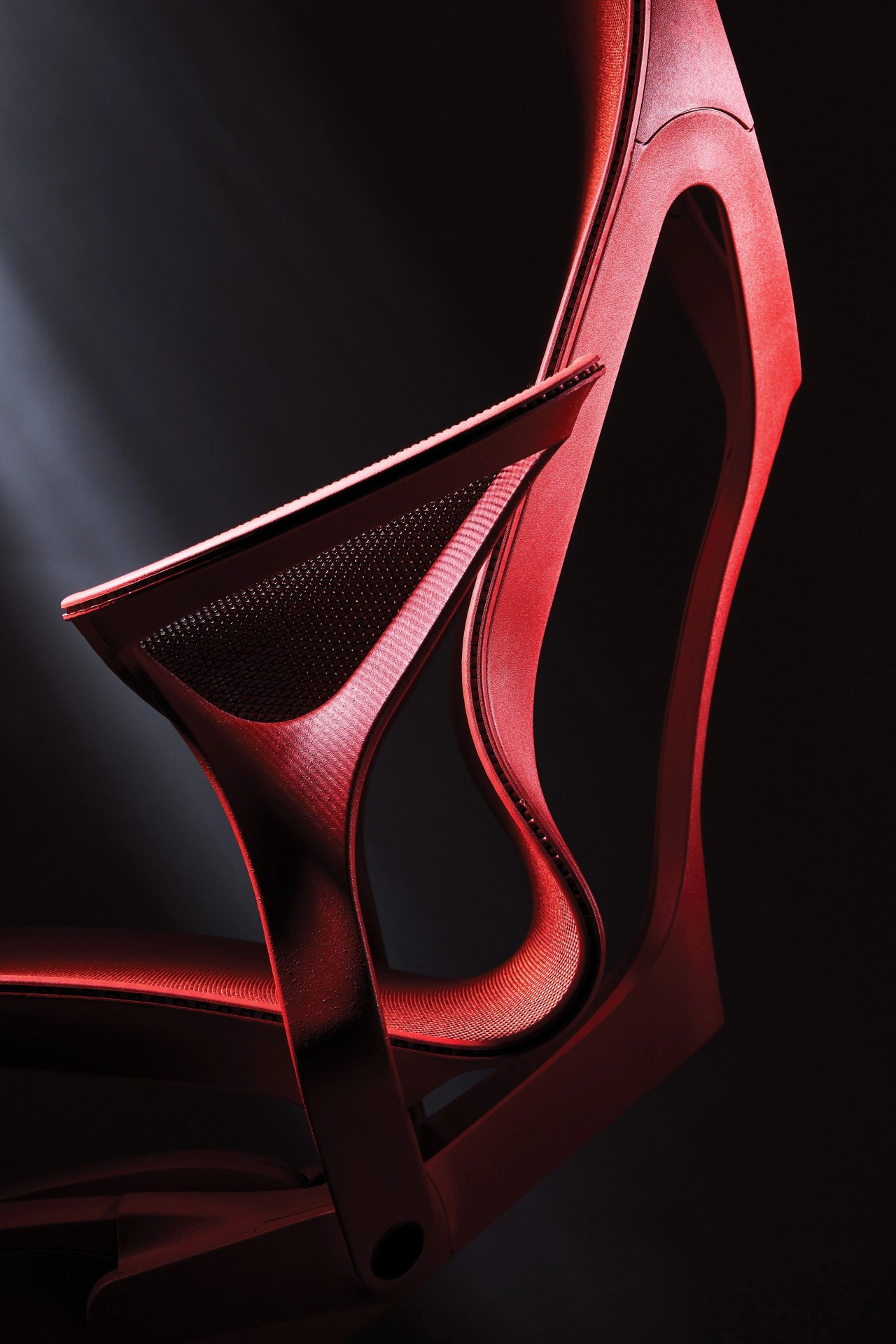 close up of a red herman miller cosm office chair