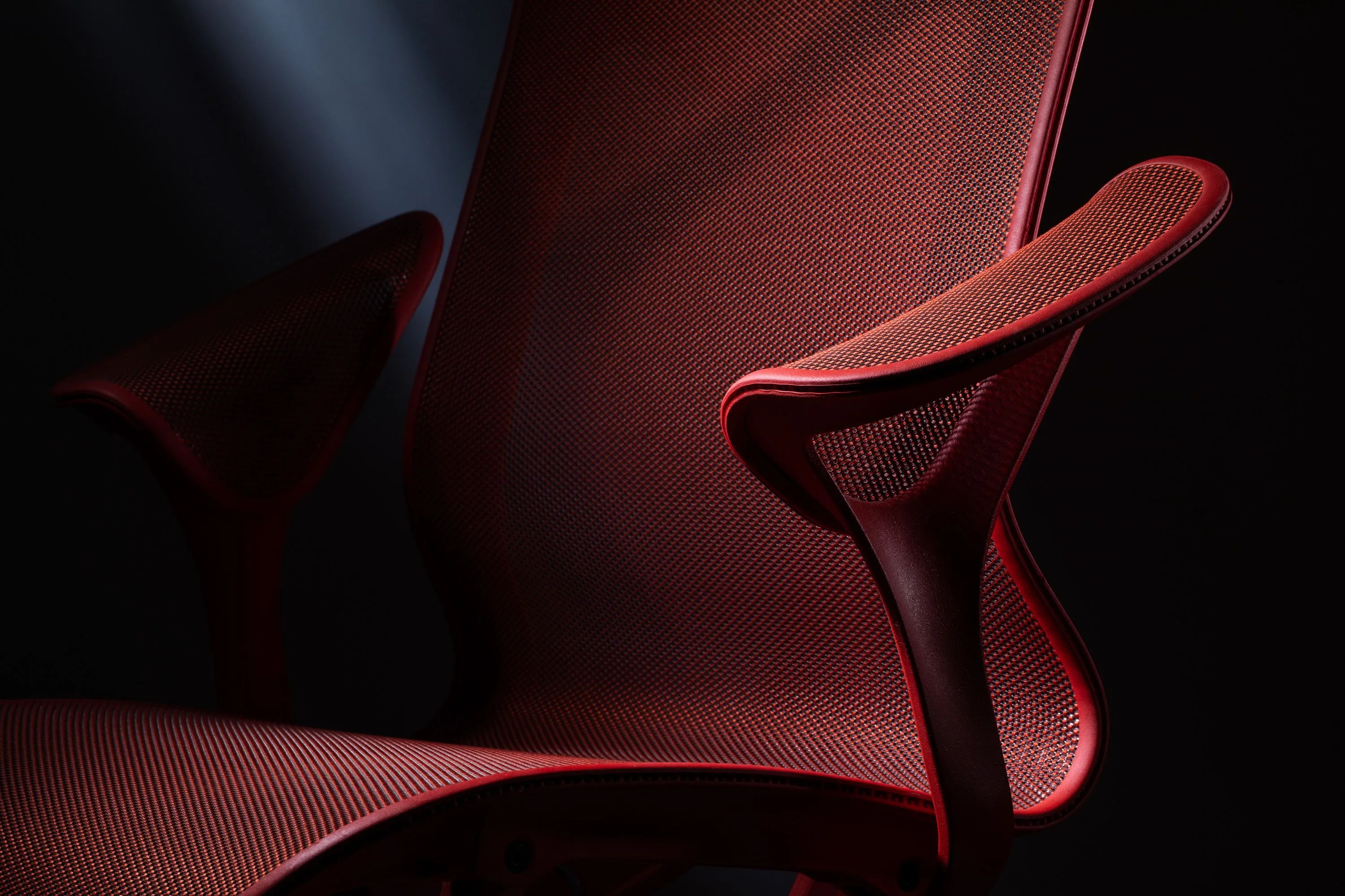 close up of a red herman miller cosm office chair
