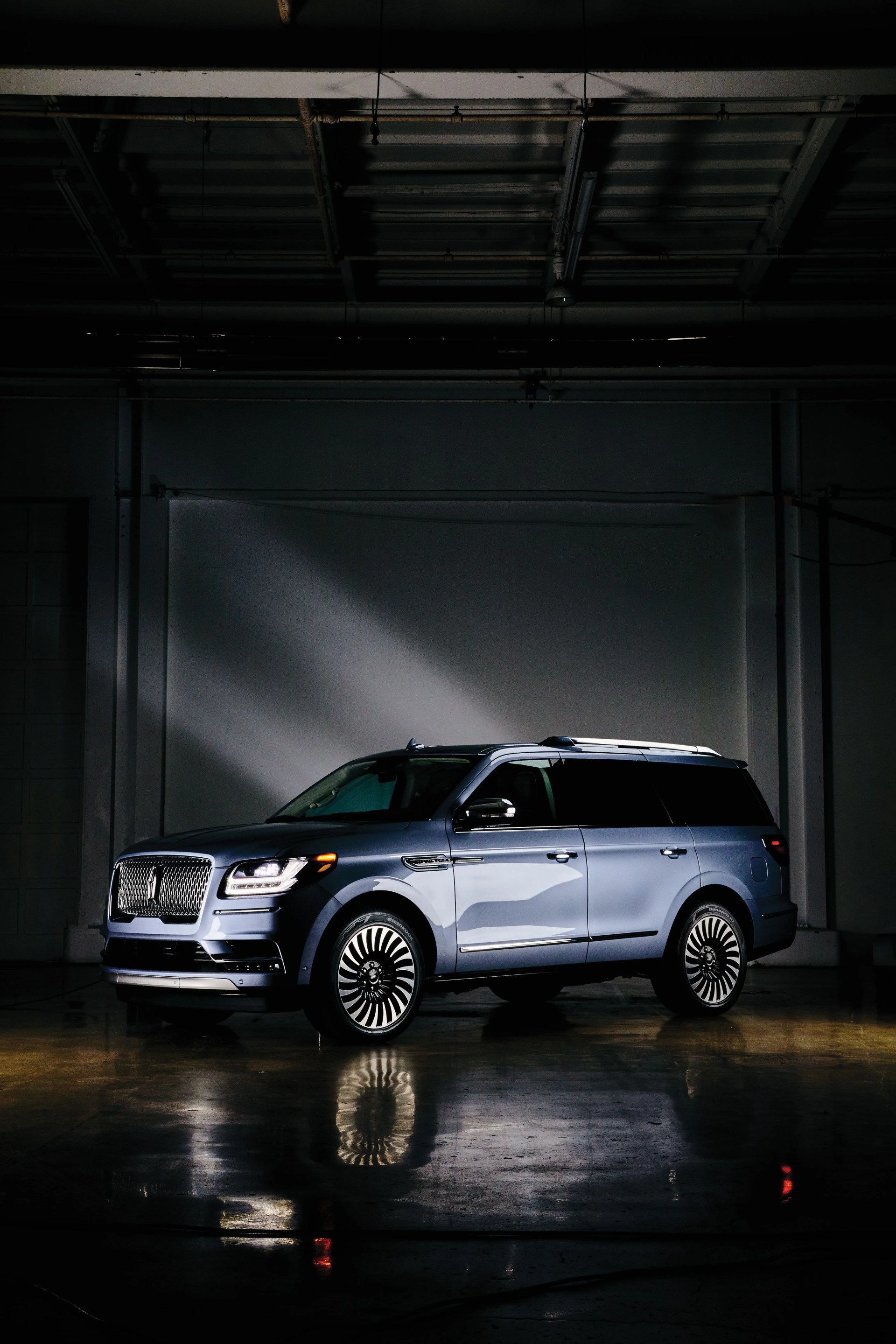 side profile of a lincoln navigator truck in the shadows