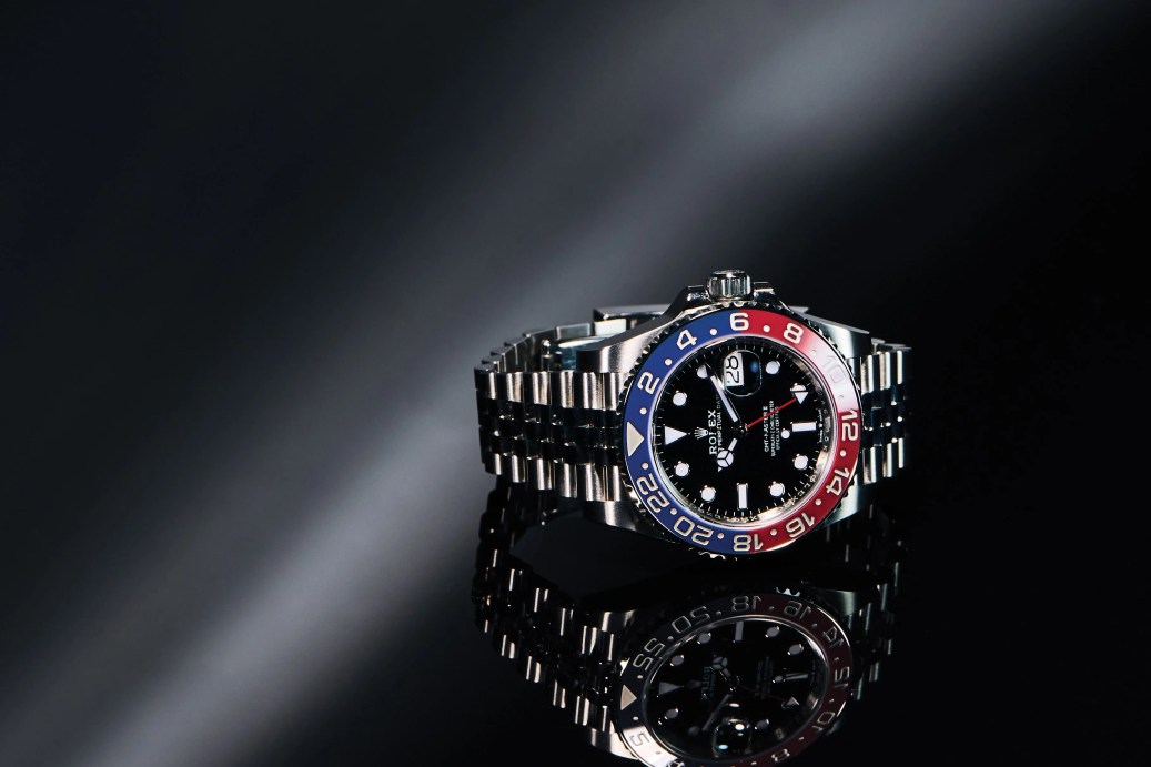 rolex gmt pepsi bezel watch with a silver bracelet