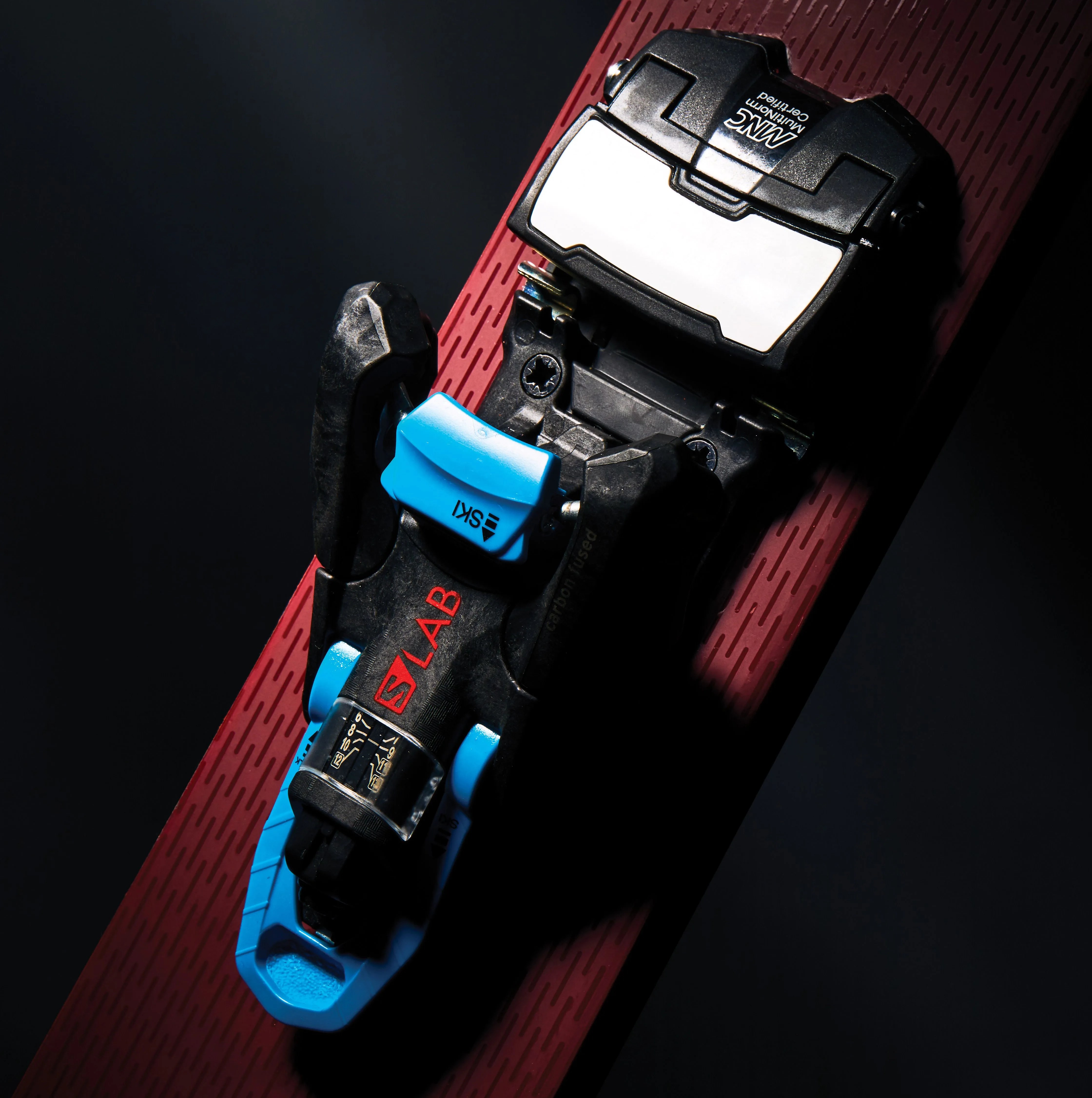 salomon ski bindings attached to a red textured ski