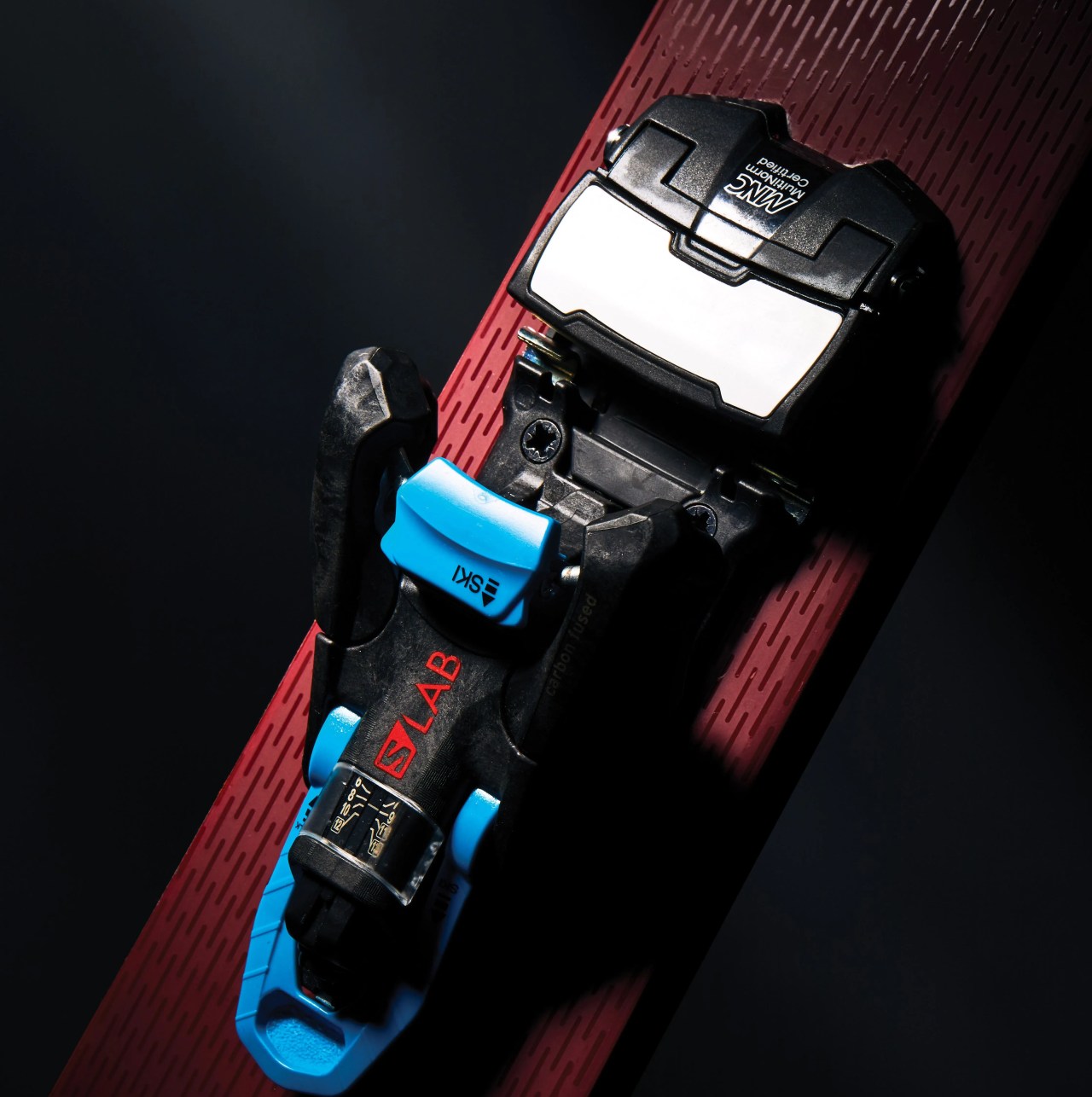 salomon ski bindings attached to a red textured ski