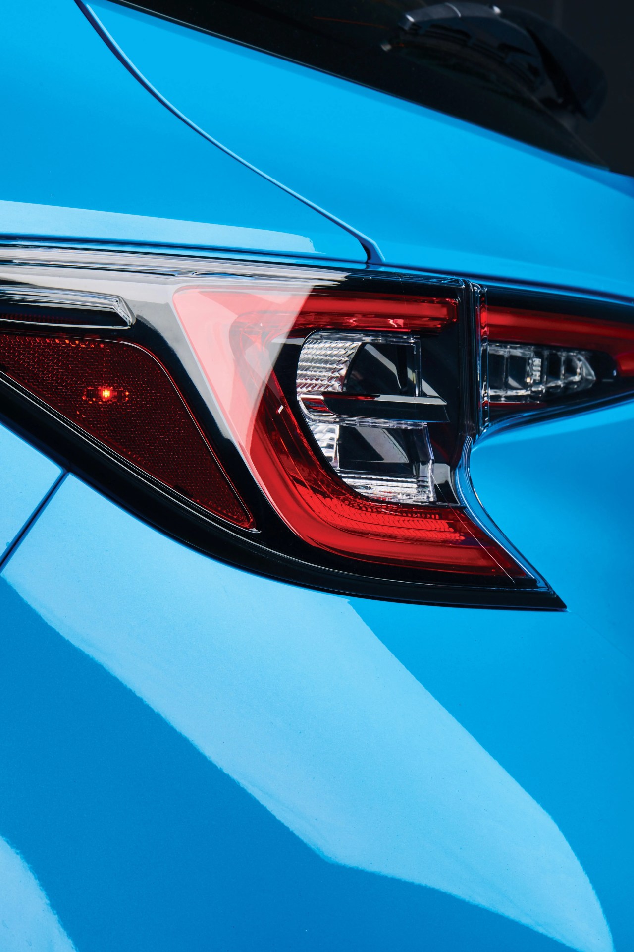 close up of the headlight on a blue toyota car