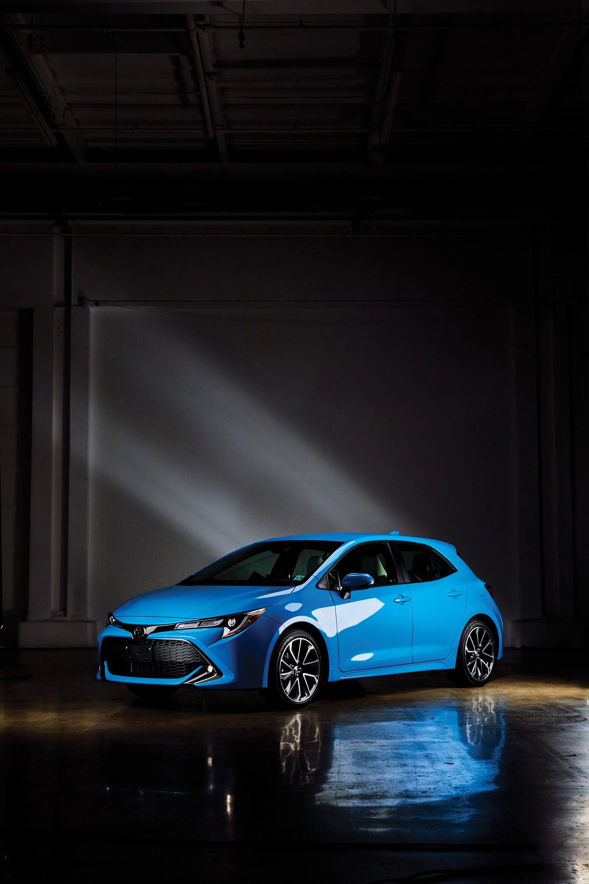 blue toyota corolla car parked facing sideways