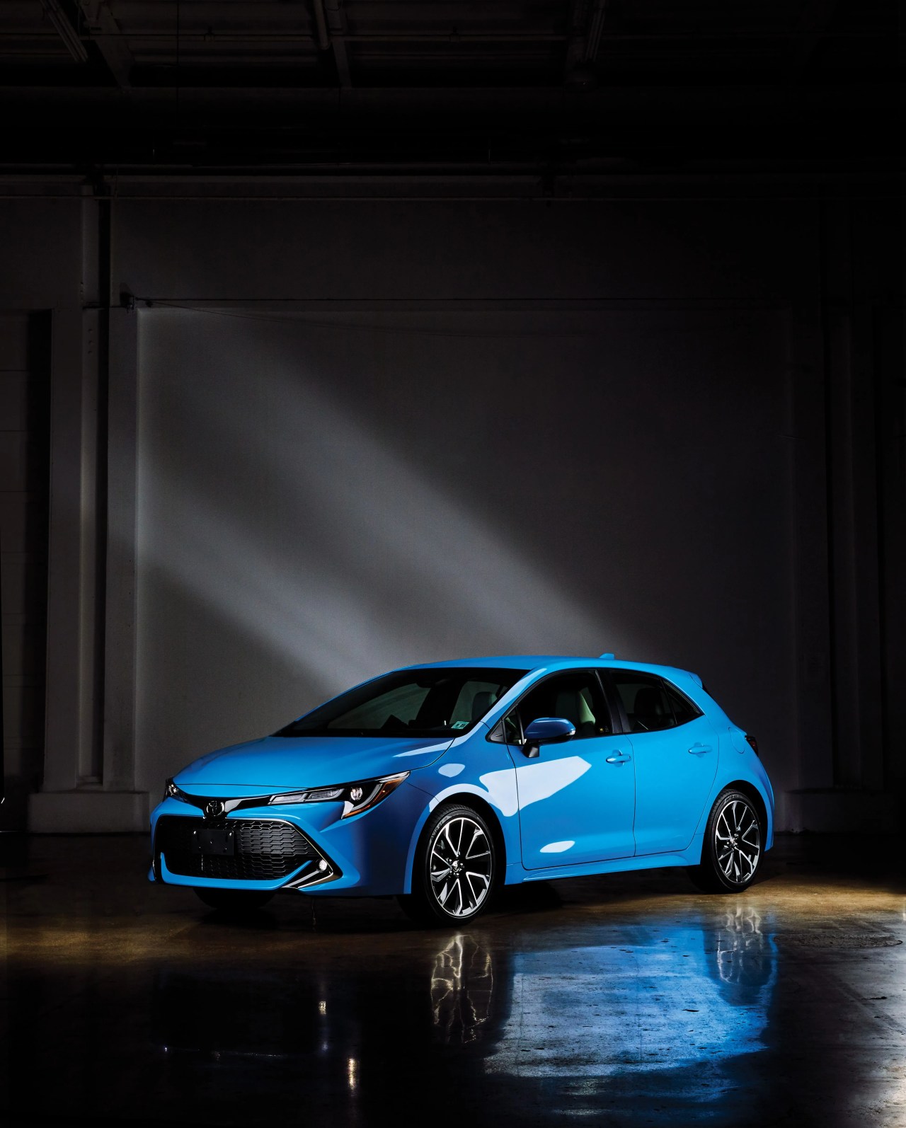 blue toyota corolla car parked facing sideways