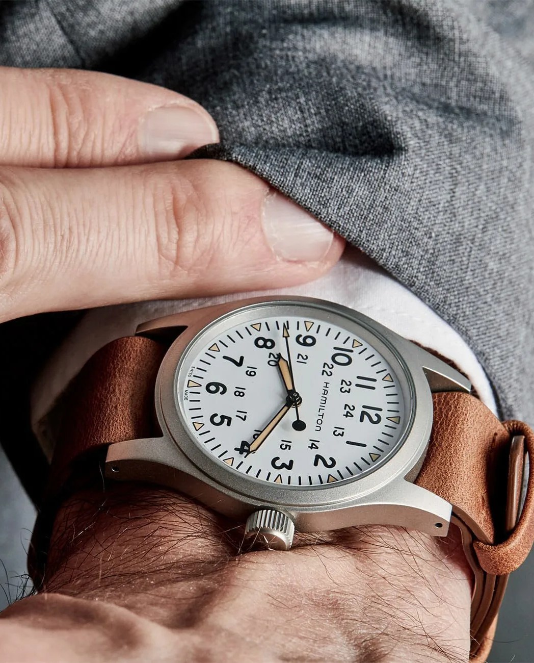 white dial hamilton khaki field mechanical watch on wrist