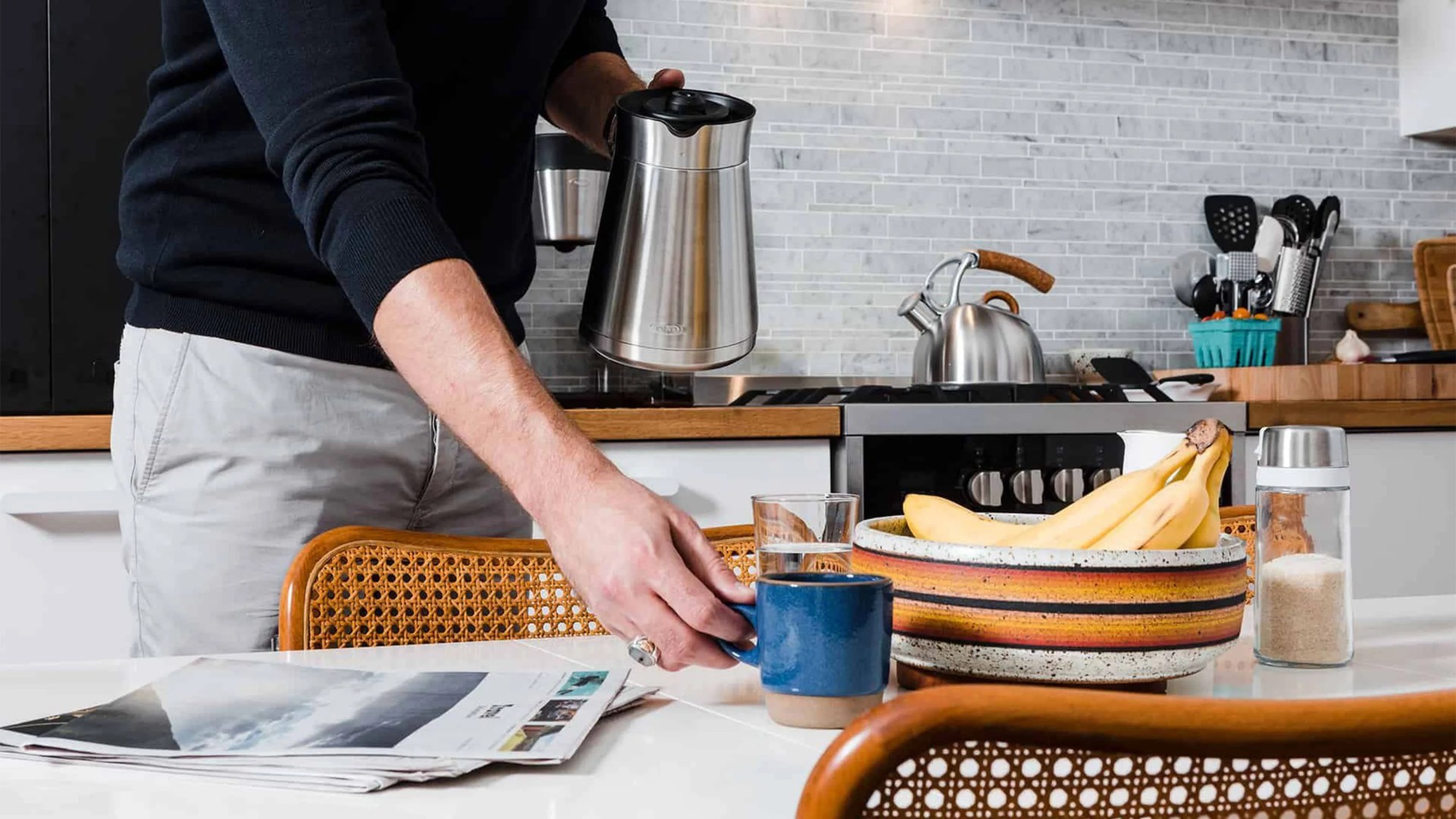 man setting blue coffee mug on dining table