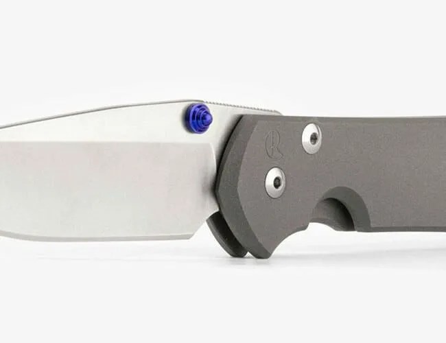 a pocket knife with a titanium handle and black lanyard viewed from two angles