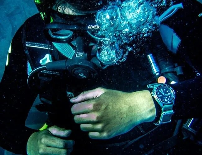 scuba diver wearing a watch