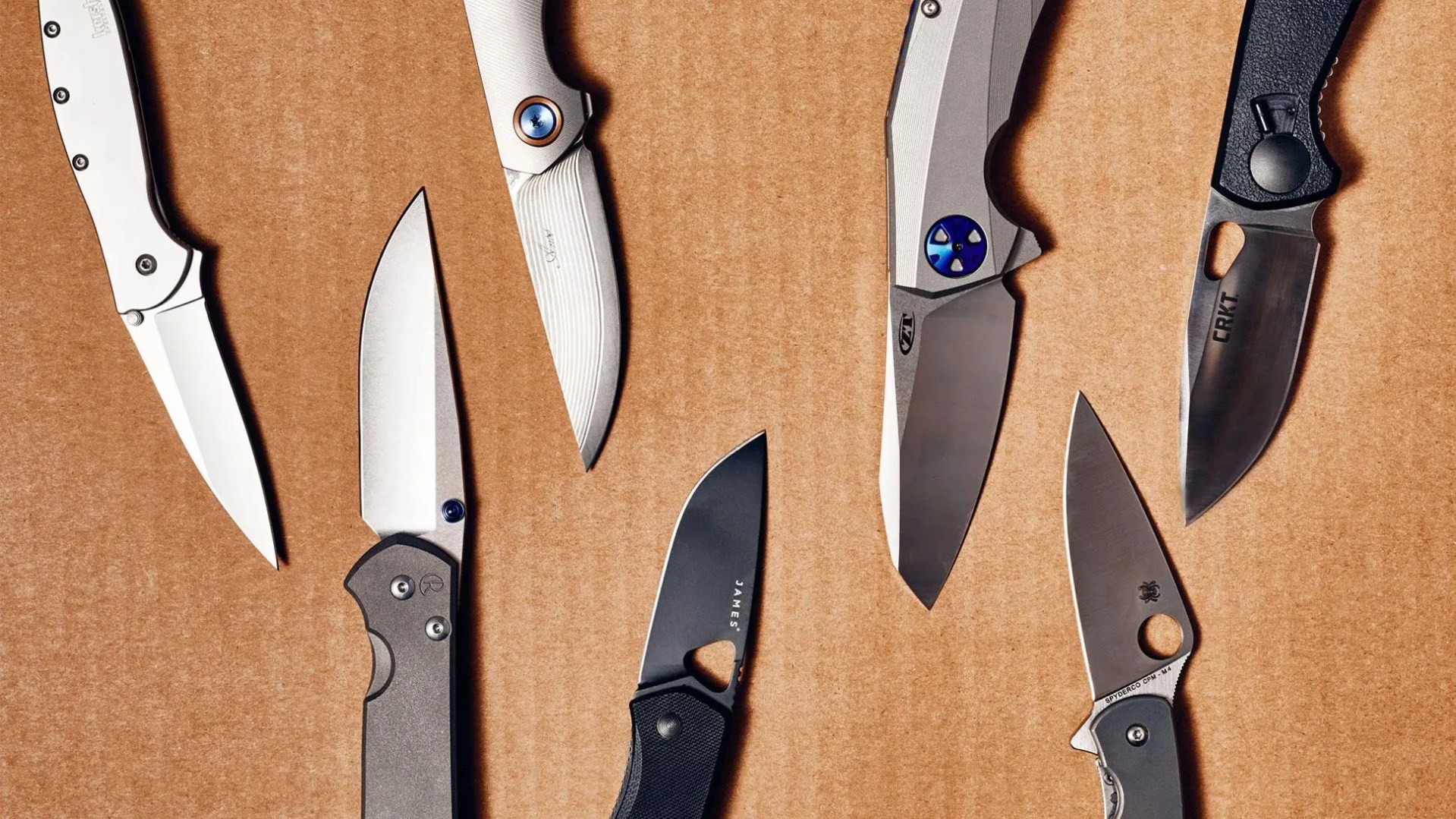 pocket knives on cardboard backdrop
