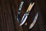 three knives on a wooden table