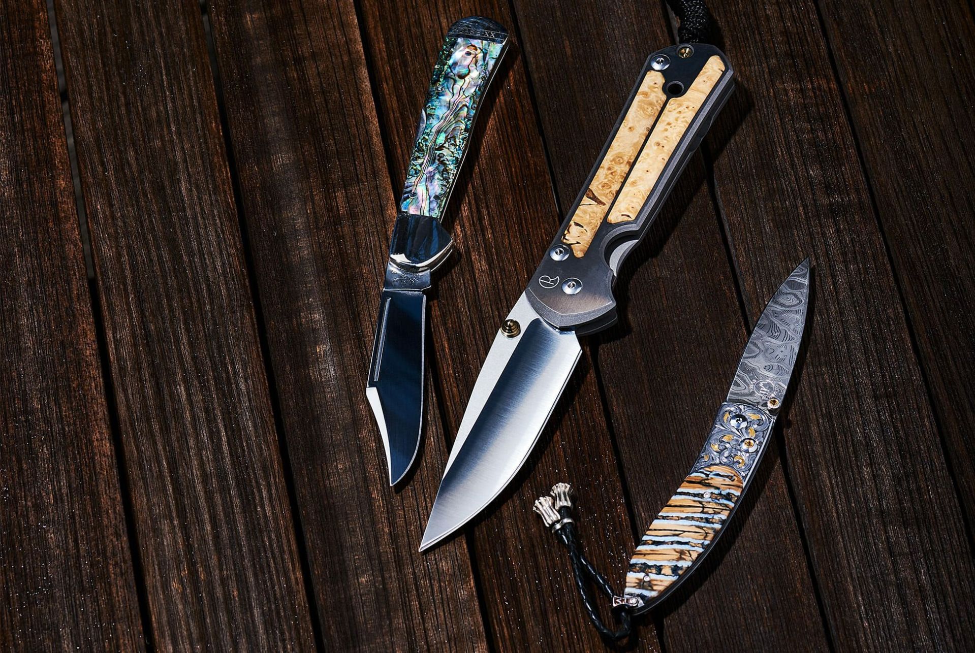 three knives on a wooden table