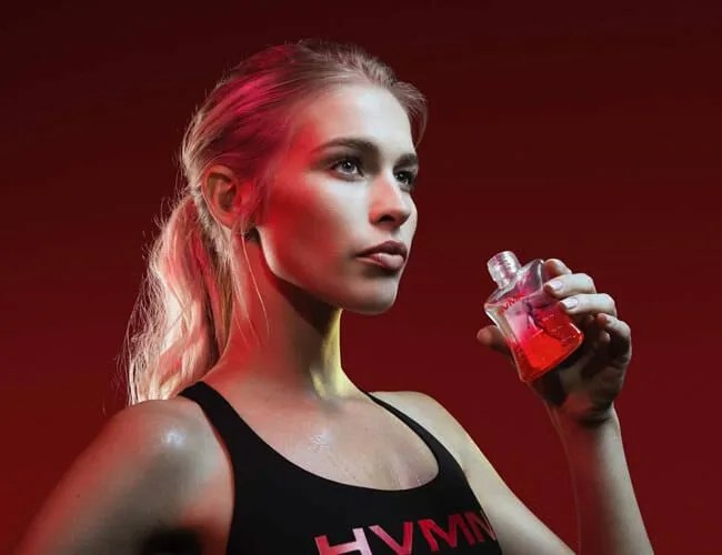 a blonde woman holding a bottle of ketones