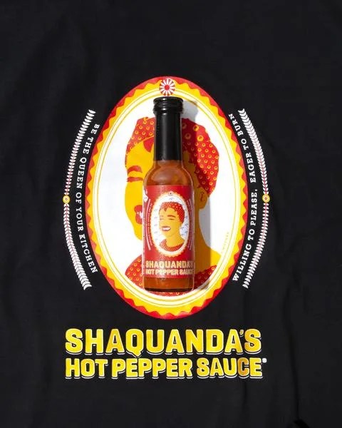 bottle of hot sauce on top of a t shirt