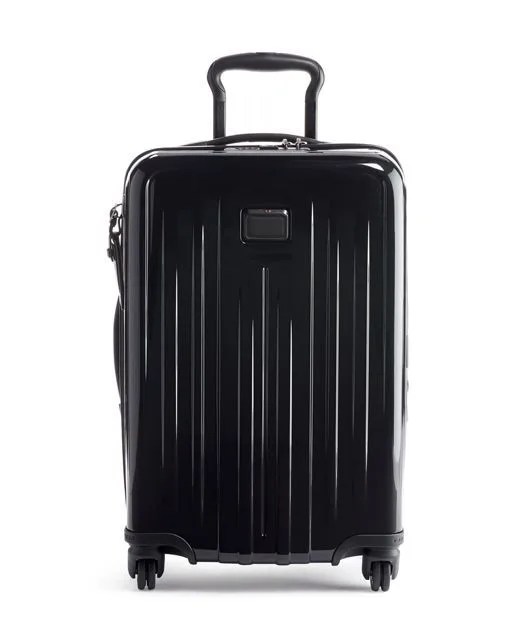 A black hardside carry on suitcase with a collapsable handle and four wheels on a white background.
