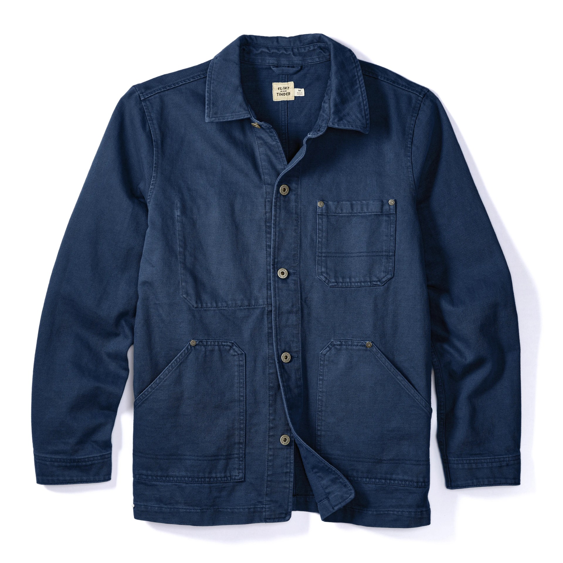 A denim chore coat on a white background.
