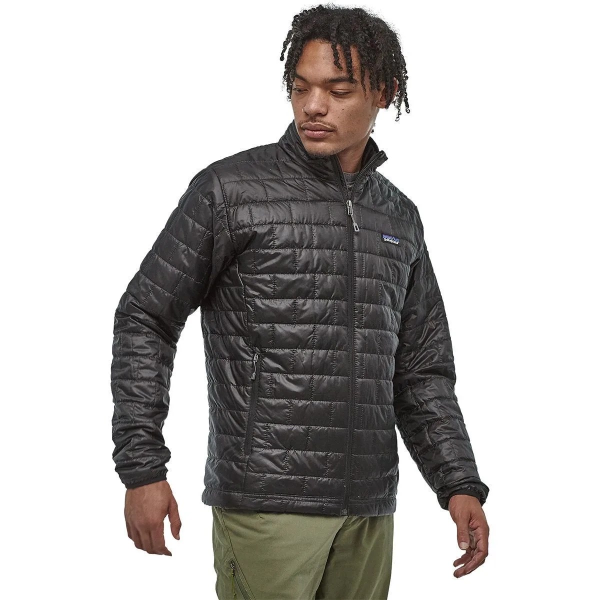 a young man wearing a black insulated jacket