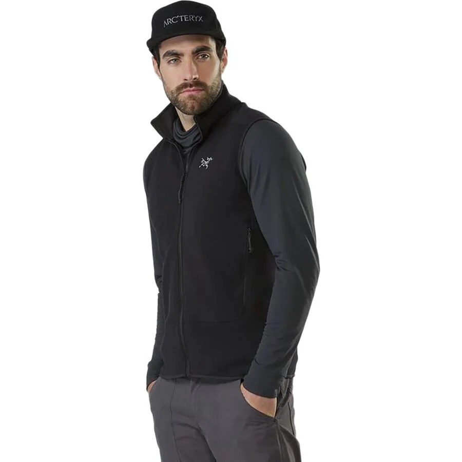 a man wearing a black hat and a black fleece vest