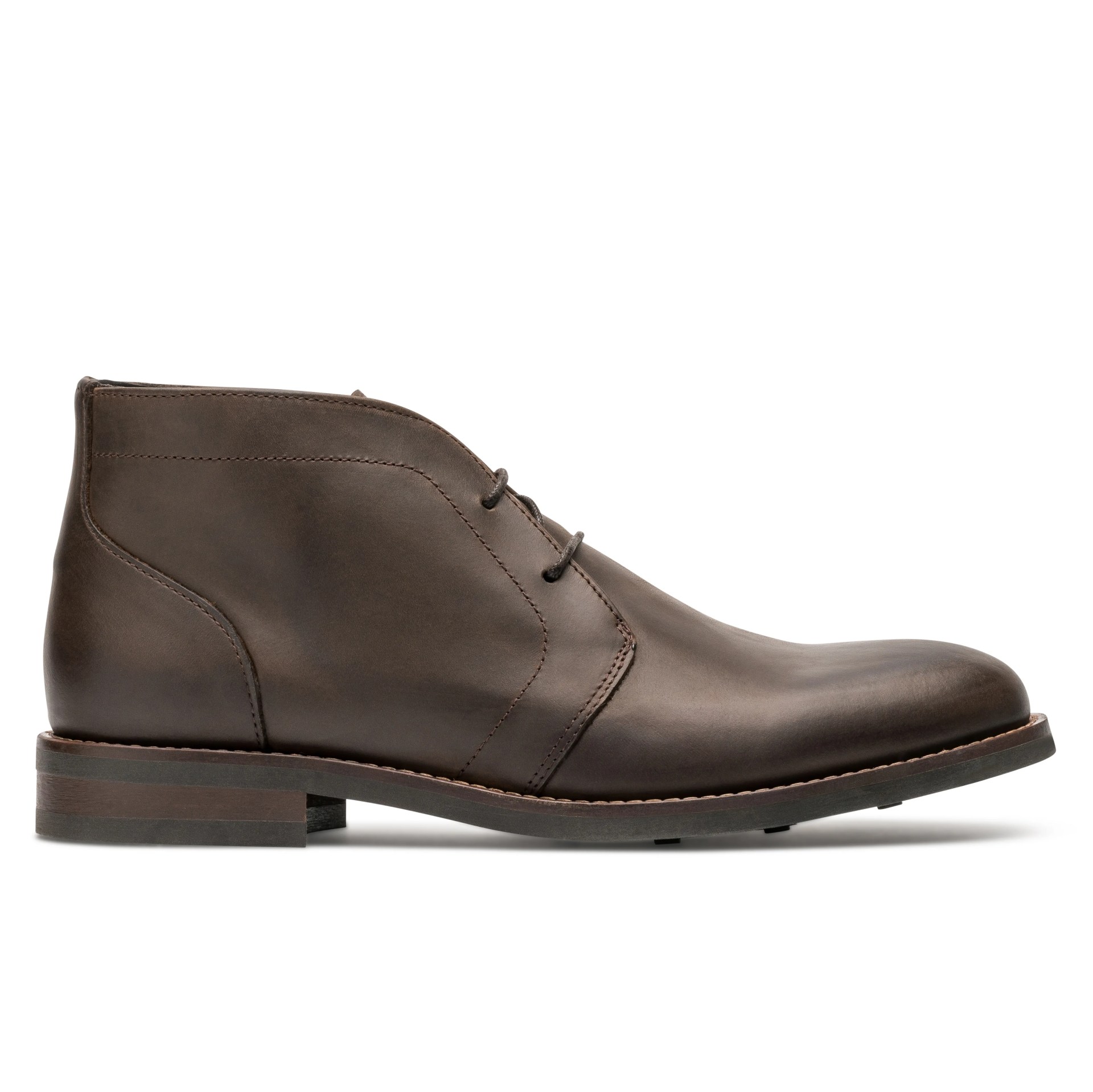A brown leather chukka boot on a gray background.