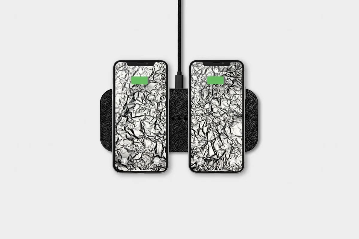 Black wireless charger with 2 smartphones charging