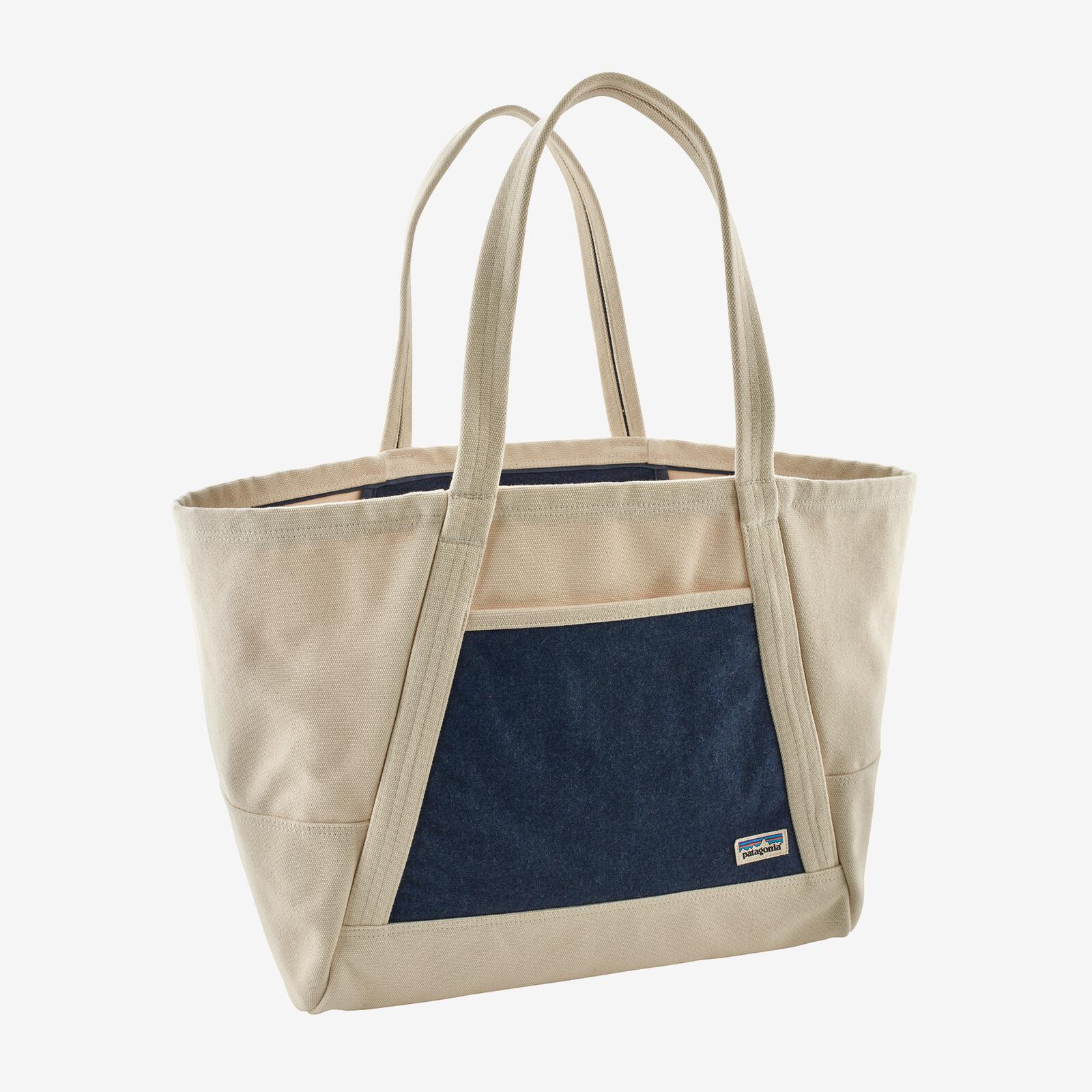 A white and denim colored tote bag on a gray background.