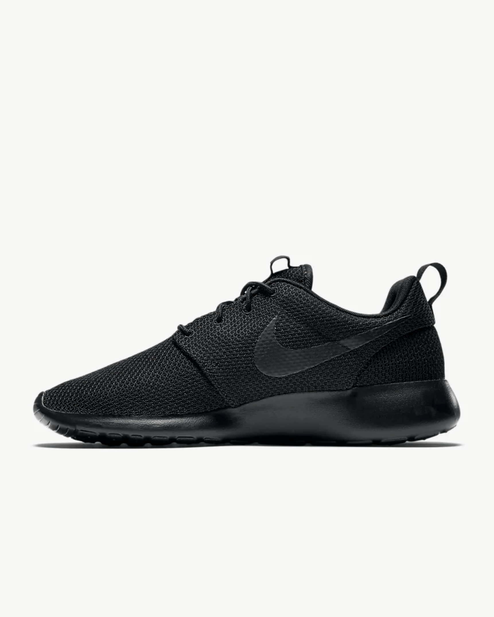 Black knit sneaker on a gray background.