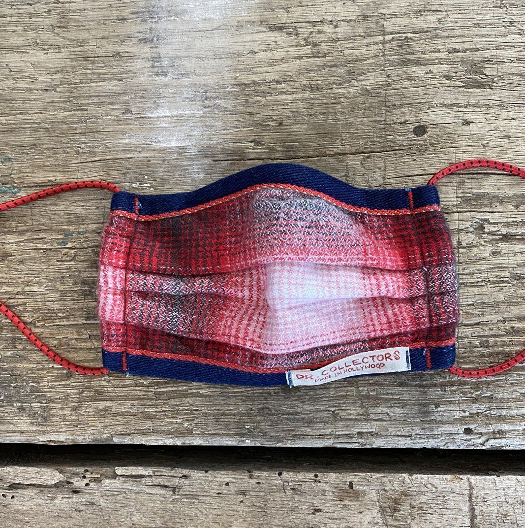red plaid face mask on wood surface