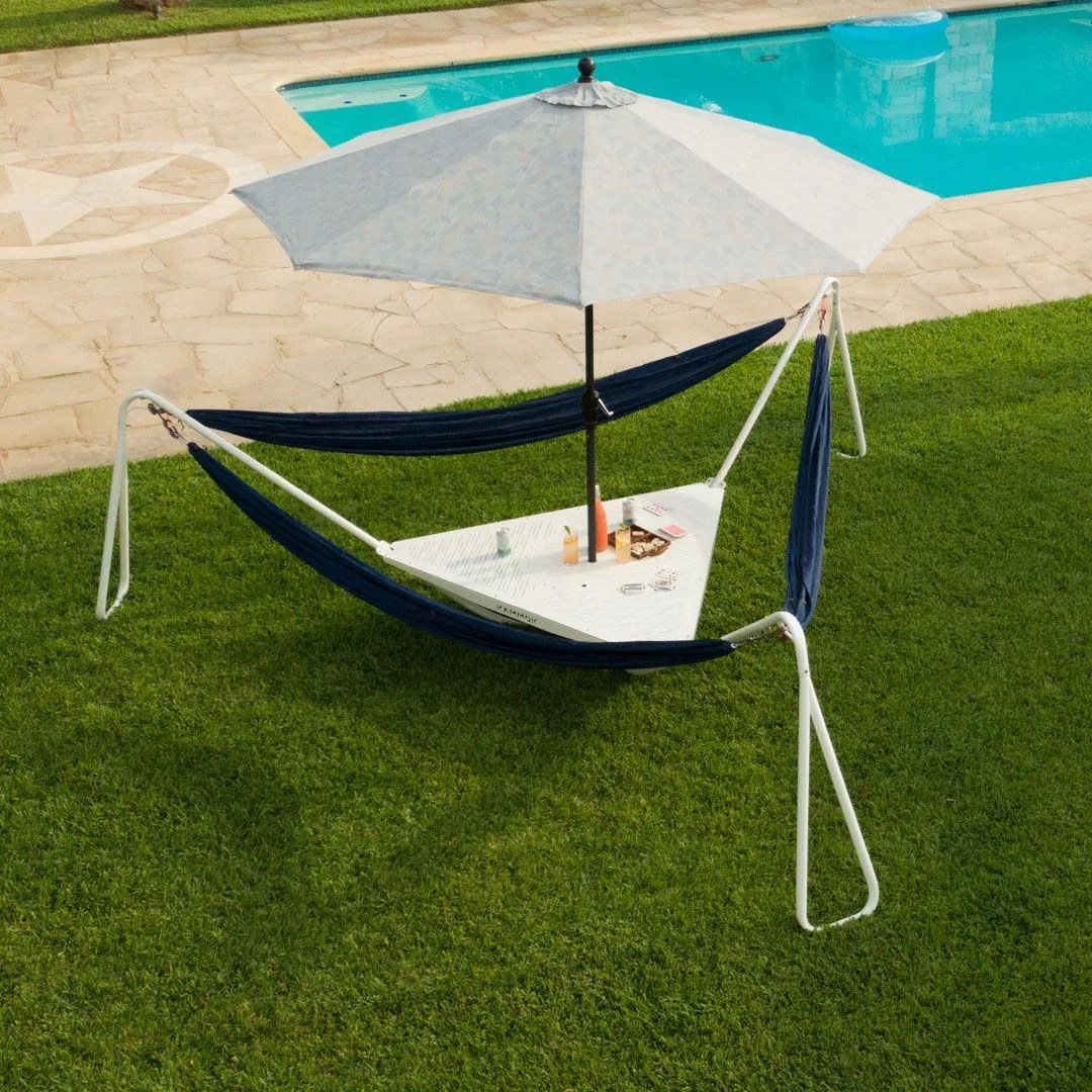 a piece of furniture consisting of three hammocks, a table, and an umbrella