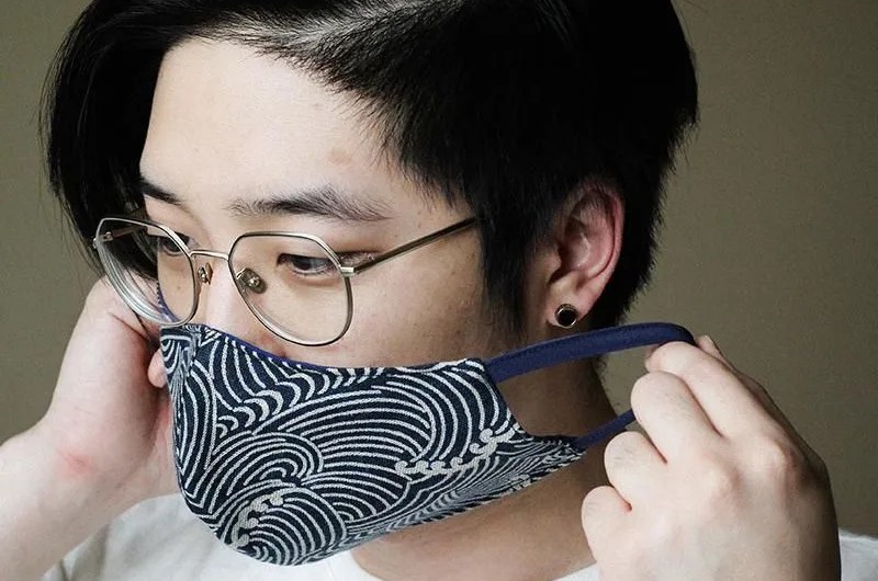 model wearing blue and white face mask