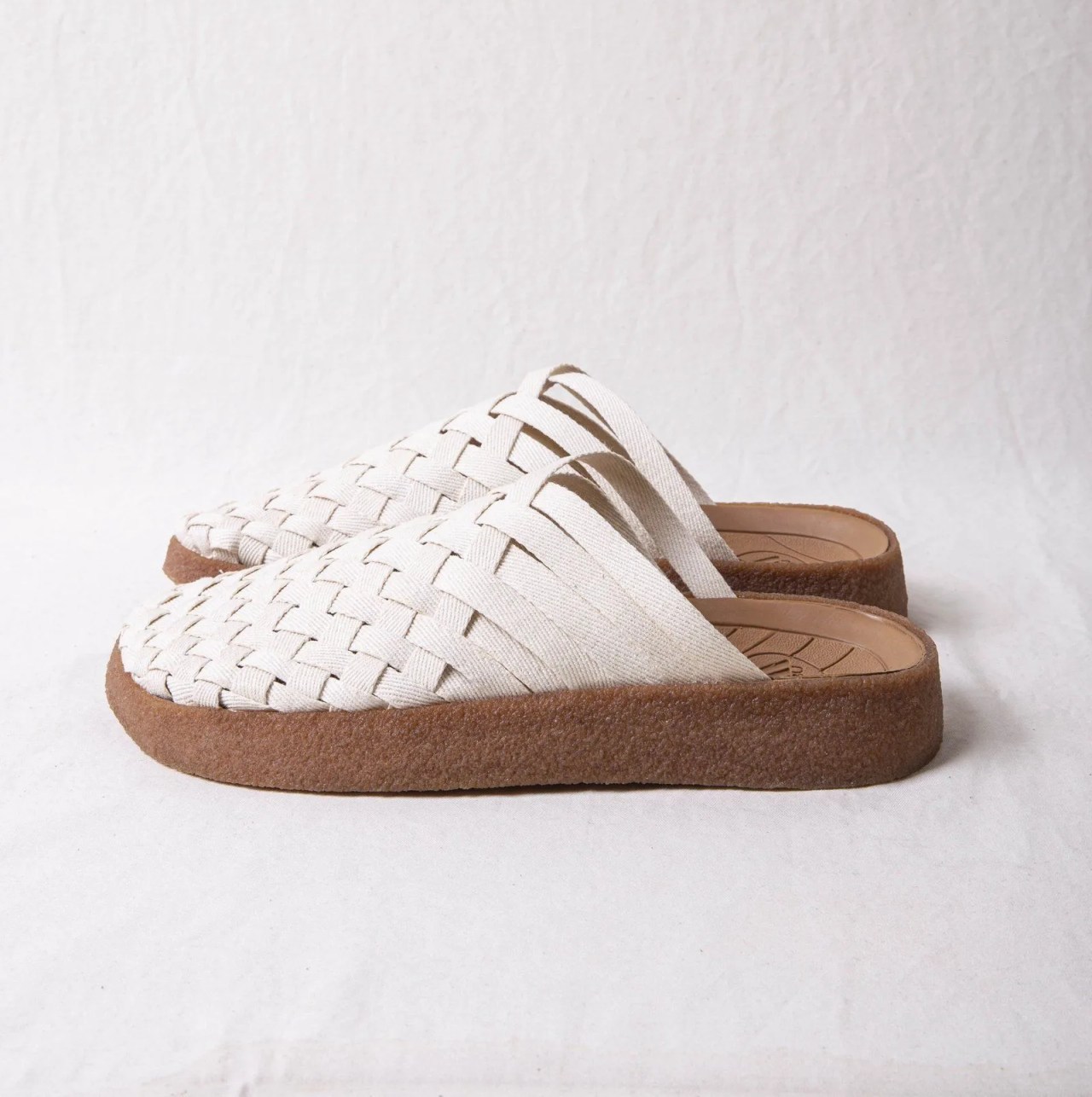 white and tan woven sandals