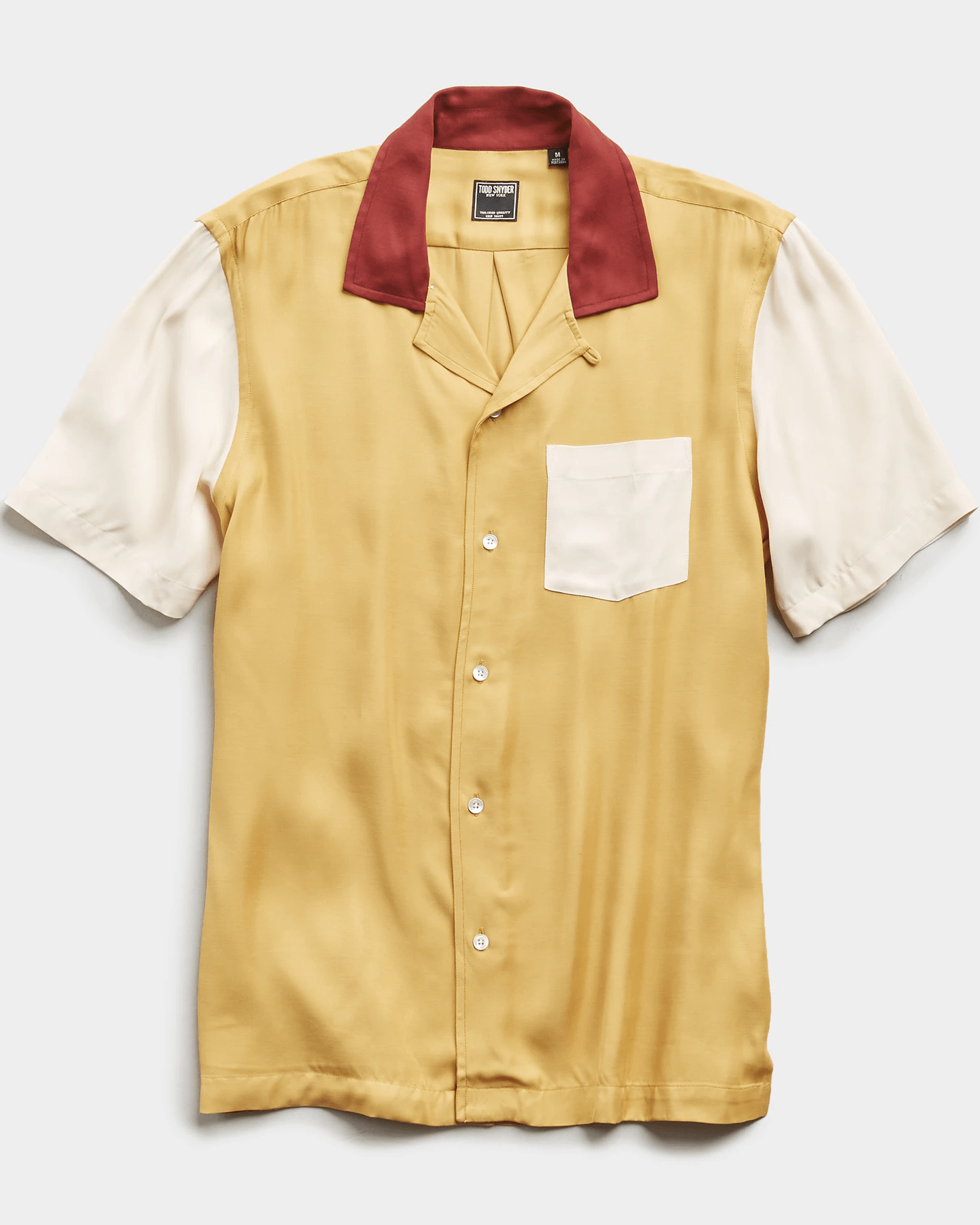 yellow bowling shirt with red collar