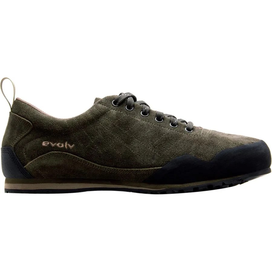 sideview of a dark green shoe with black rubber toe and heel caps