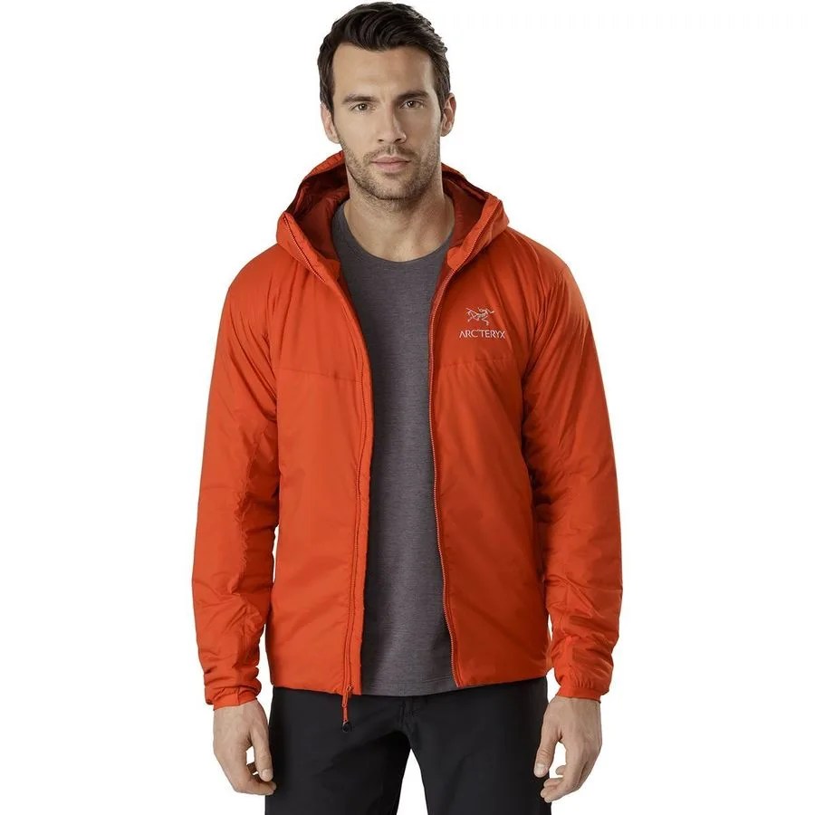 a man wearing an unzipped red-orange jacket