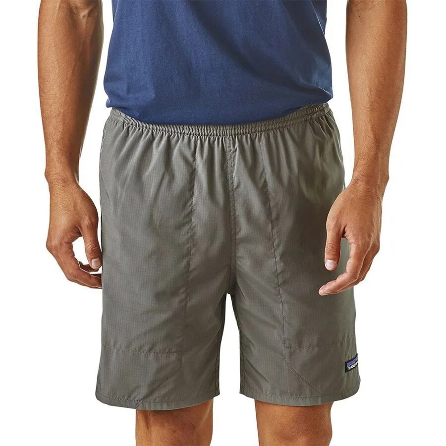 the bottom half of a man wearing gray shorts made of technical fabric