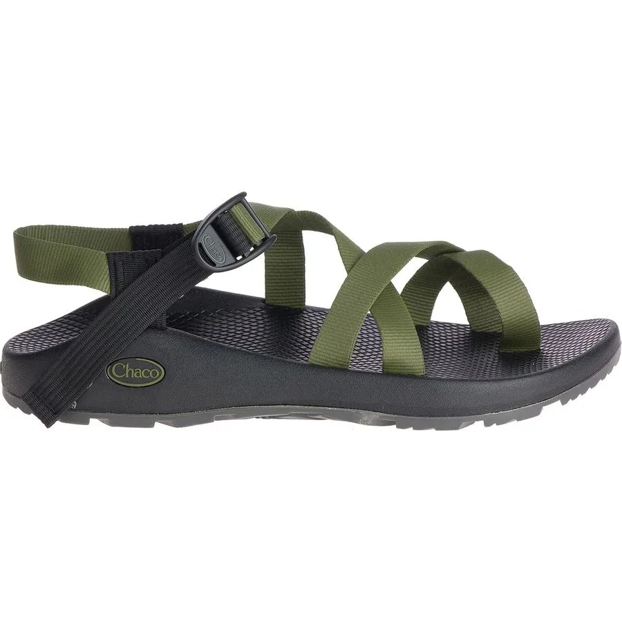 side view of a sandal with green straps and a black sole